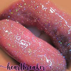Lip gloss with pink glitter, glossy finish, and "heartbreaker" text overlay