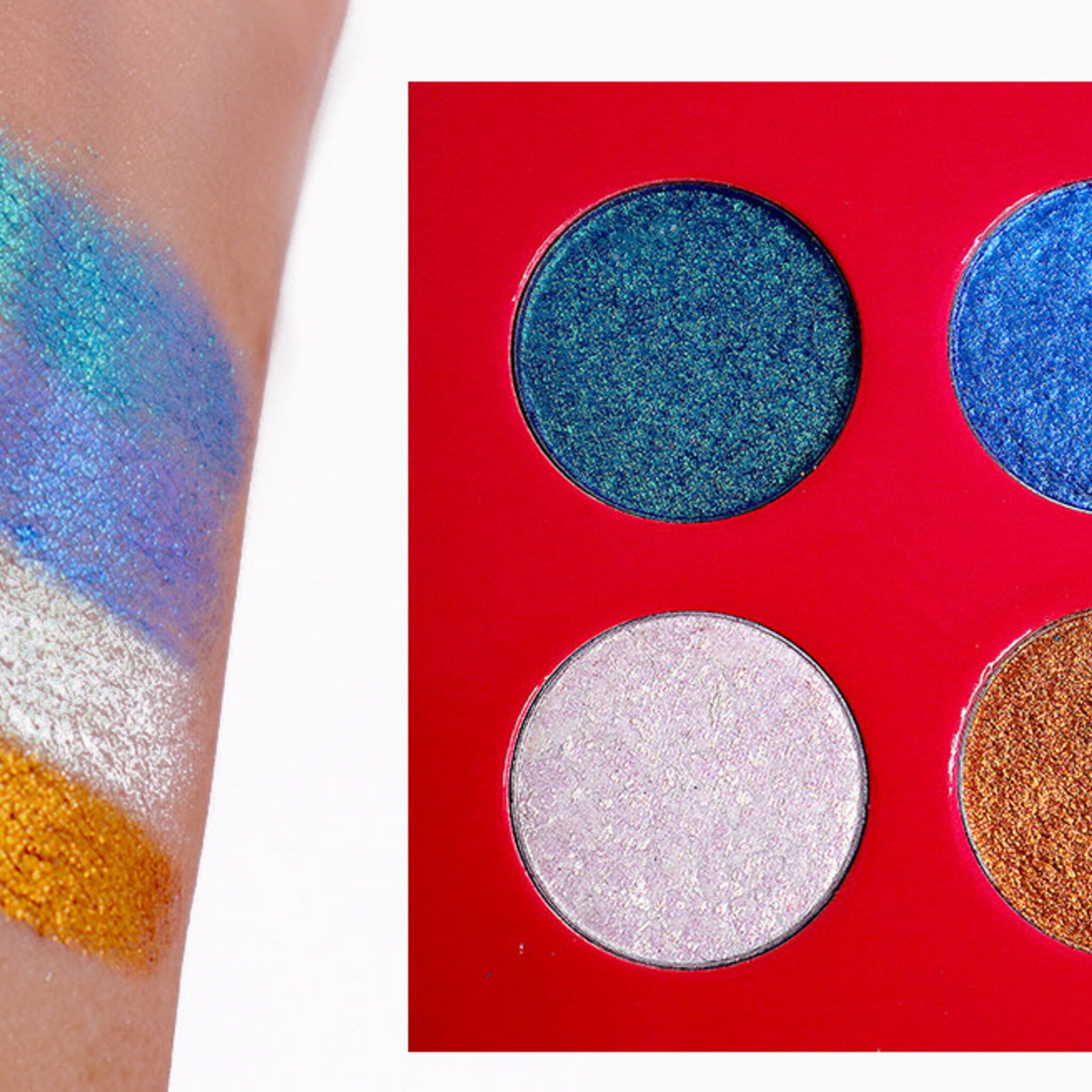 Eyeshadow palette with blue, green, white, and gold shimmer eyeshadows on a red background and arm