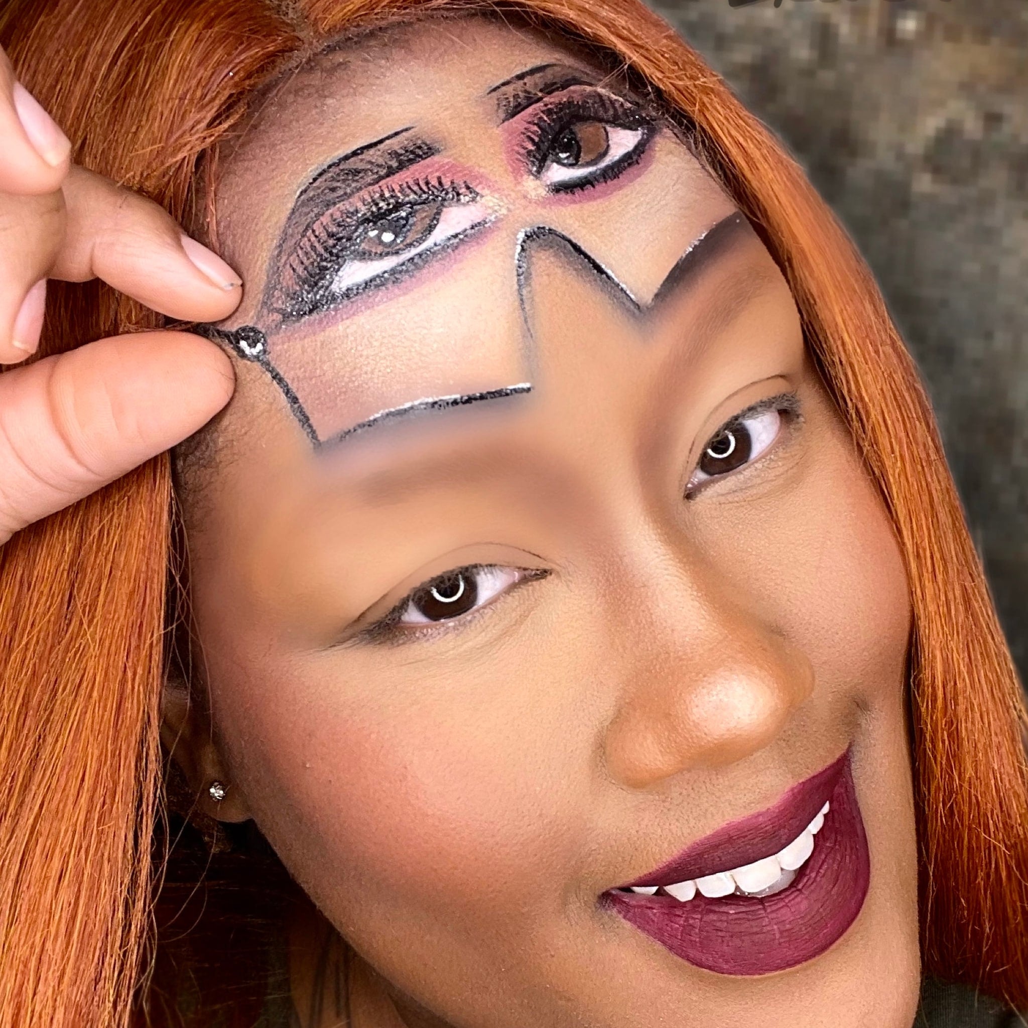 Makeup look with painted eyes, silver accents, and burgundy lipstick on smiling face
