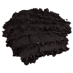 Close-up of matte dark purple loose mineral eyeshadow with rich aubergine pigment in a jar
