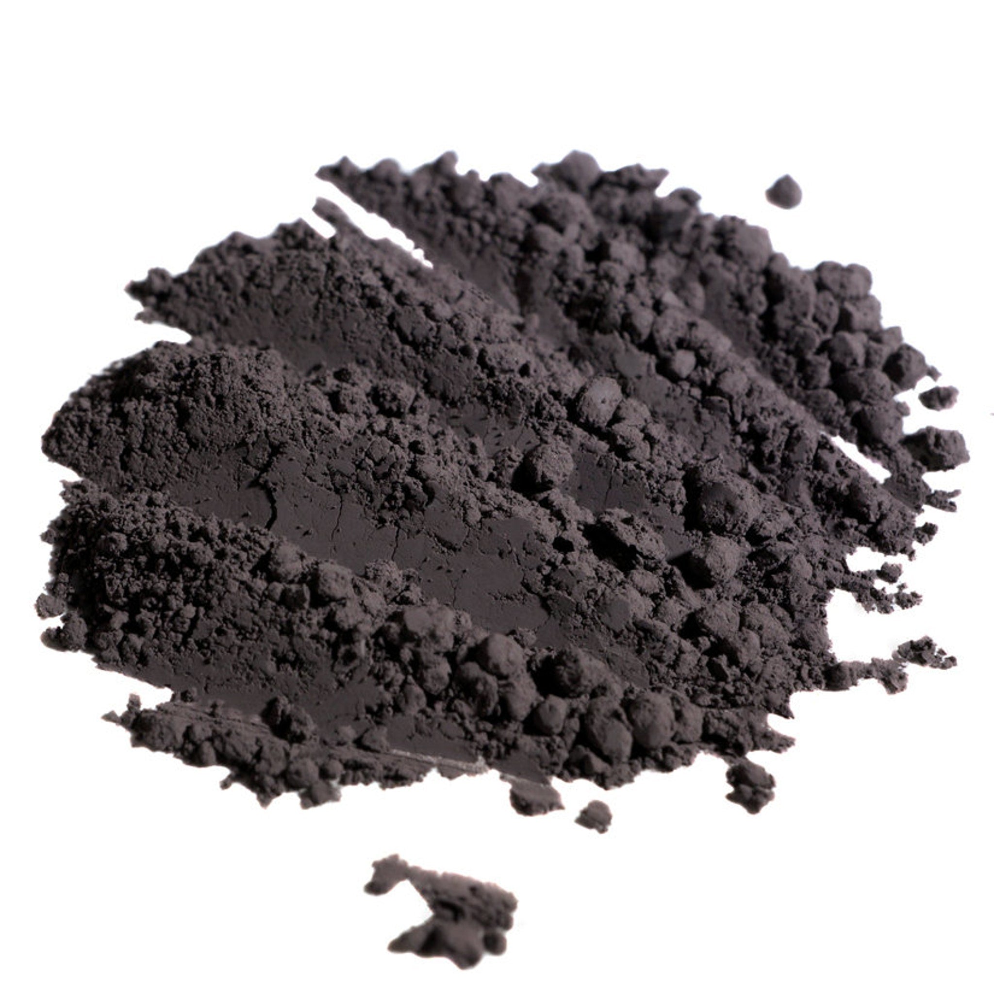 Hand applying matte dusty violet loose pigment eyeshadow with fingertip, showing rich purple-gray color payoff