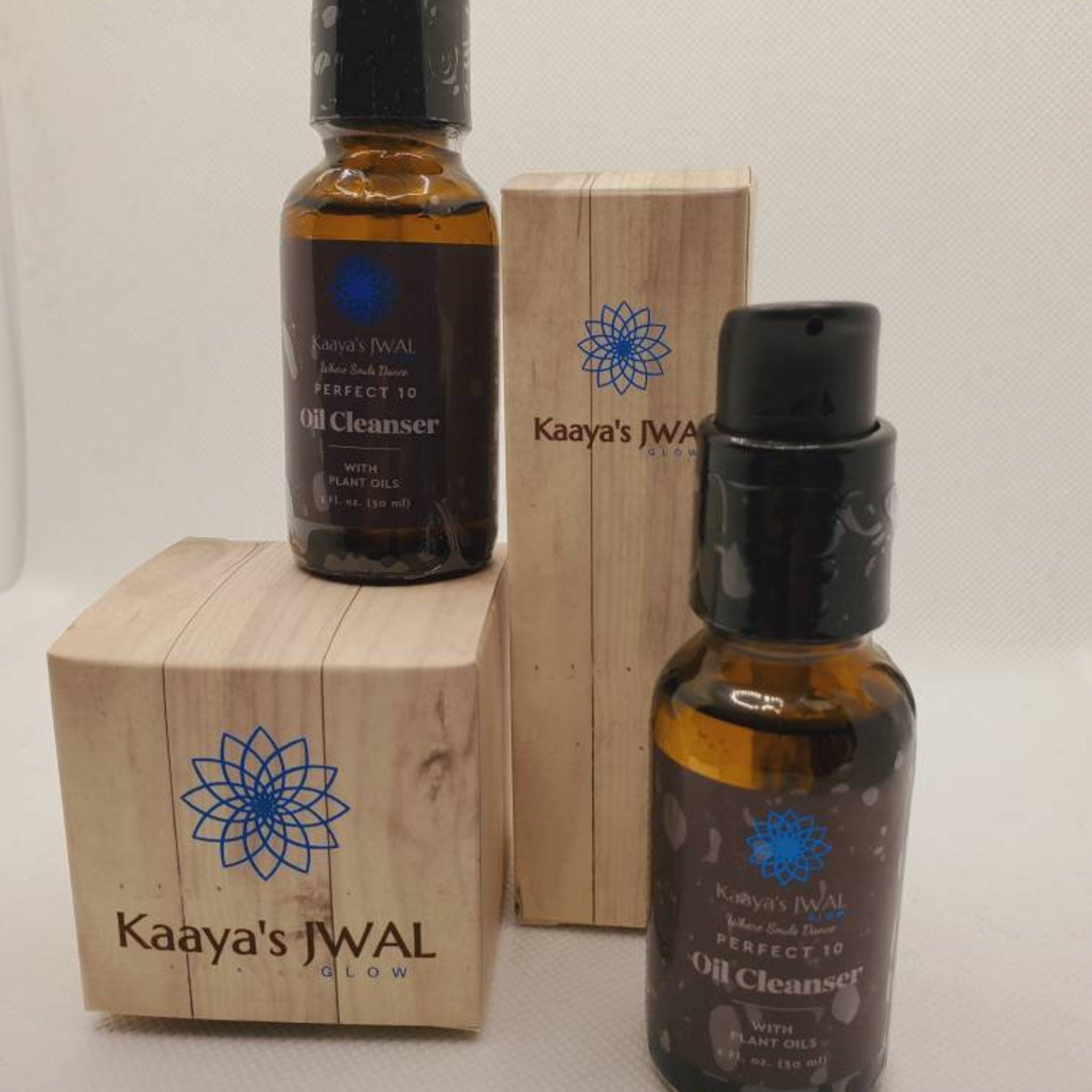 Oil cleanser bottles with brown glass, black cap, and wooden box with logo and text