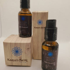 Oil cleanser bottles with brown glass, black cap, and wooden box with logo and text