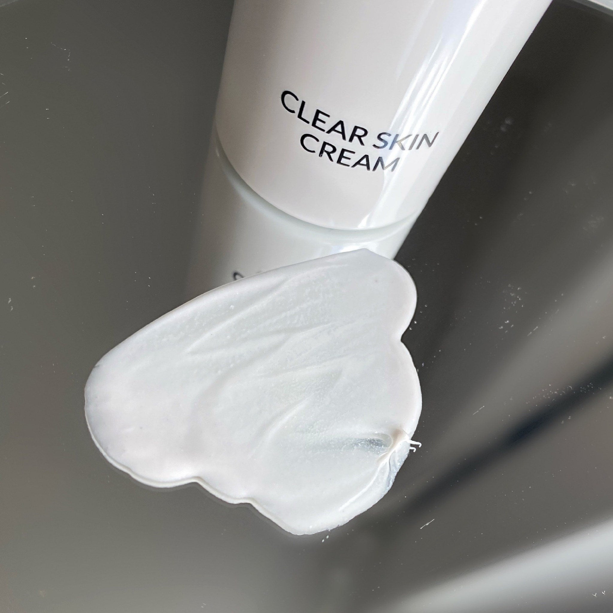 Clear skin cream with white color, smooth texture, and "Clear Skin Cream" text on tube.