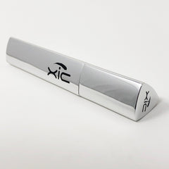 Silver tube with black "xic" logo, metallic finish, angled design on white background.