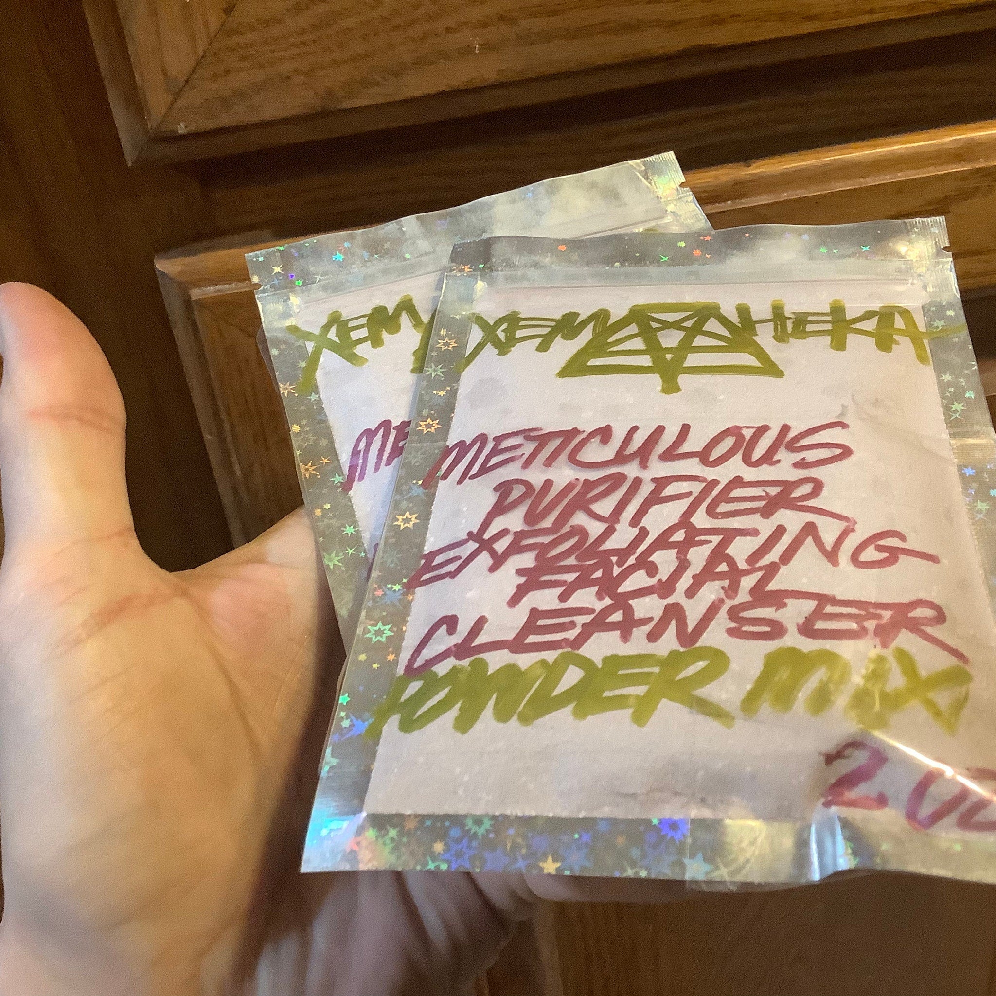 Facial cleanser powder mix in clear plastic packaging with star pattern and handwritten text