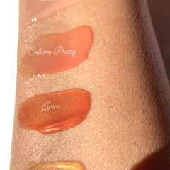 Lip gloss swatches, orange and bronze shades, on skin, with "Spice" text