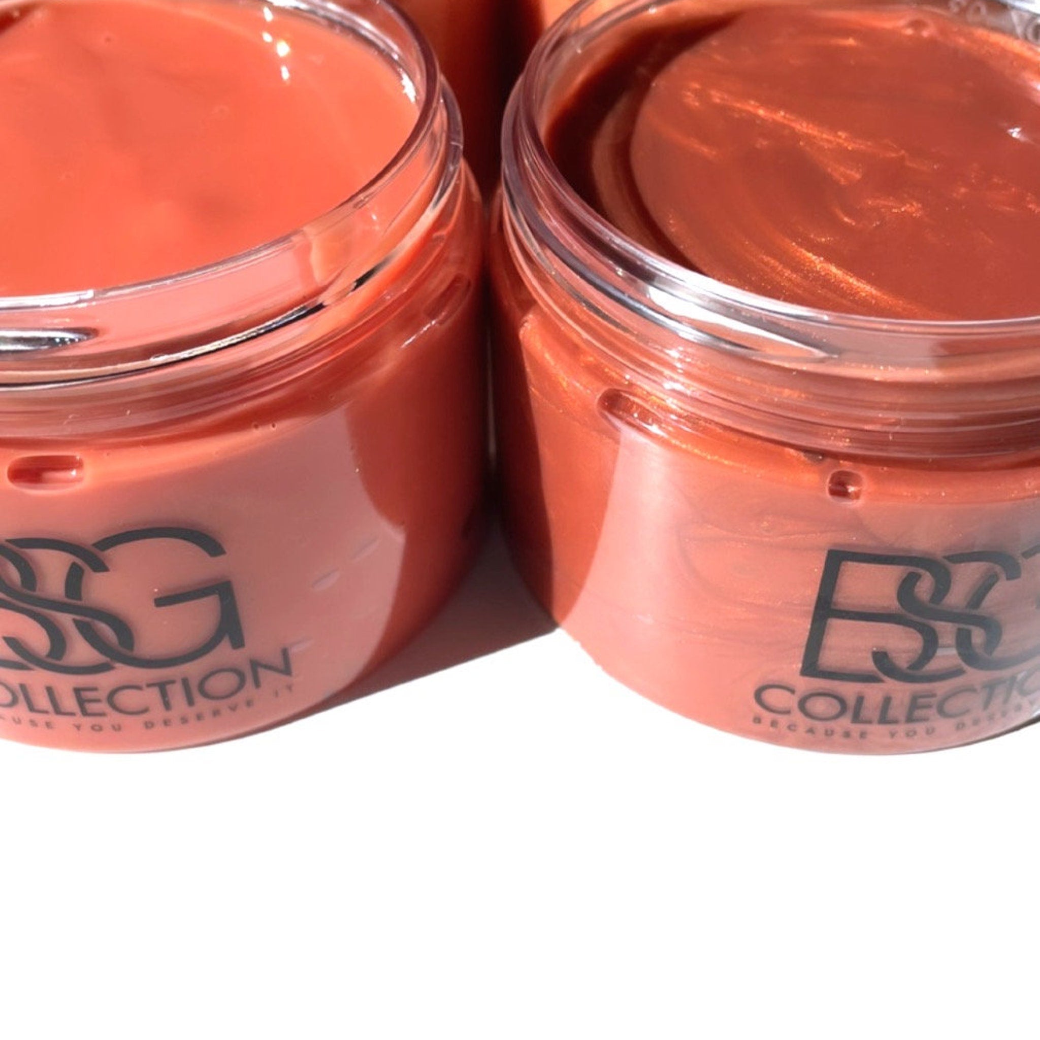 Lip gloss in jars, coral color, glossy finish, with "BSG Collection" text on jar.