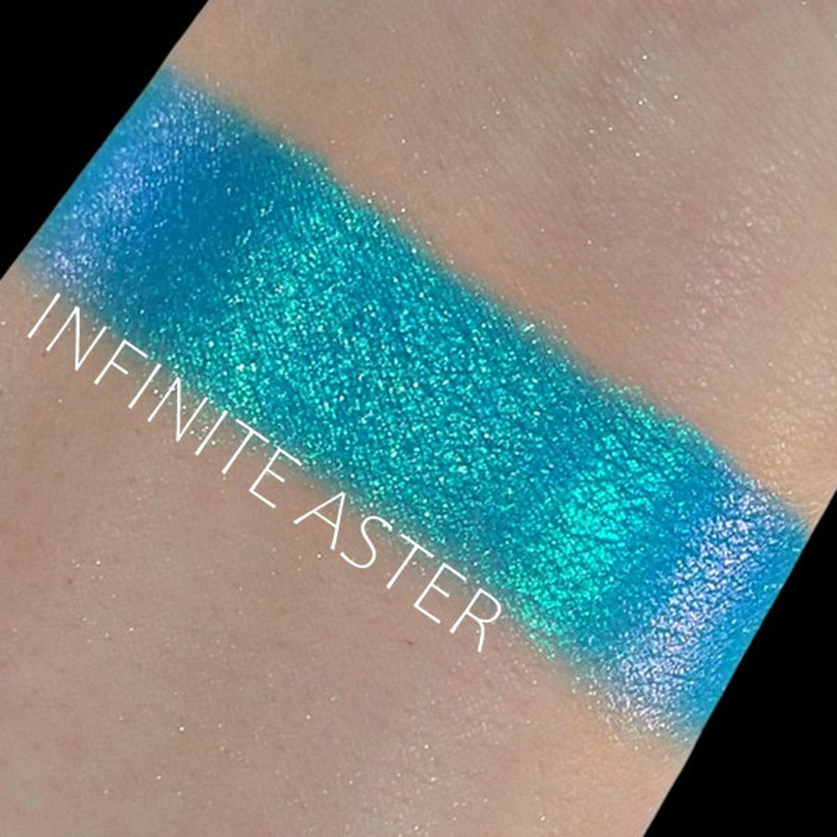 Close-up of Duochrome Shifting Eye Shadow in Infinite Aster showing iridescent purple-to-blue color shift in compact pan.