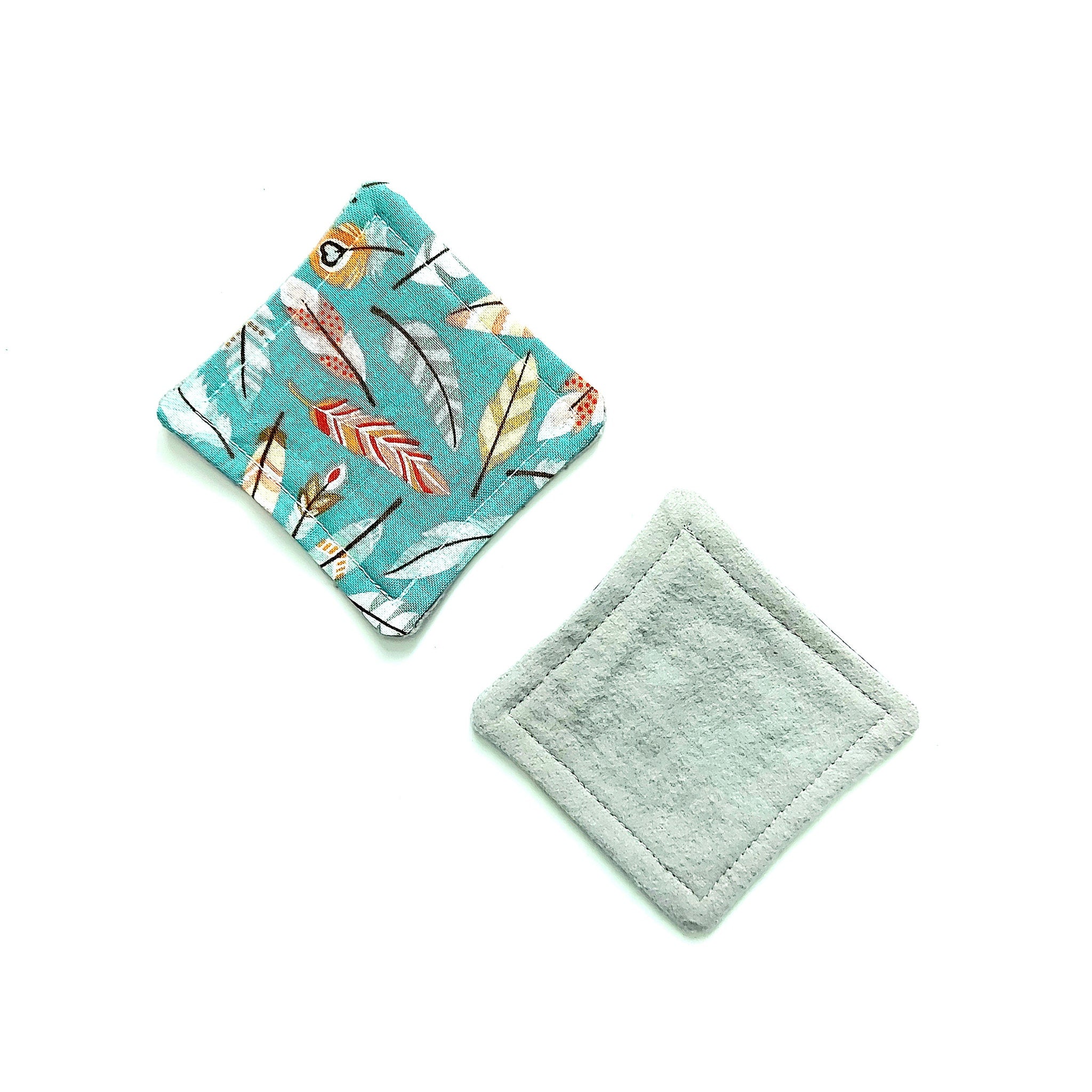 Reusable face pads with teal feather print and grey material, diamond shape