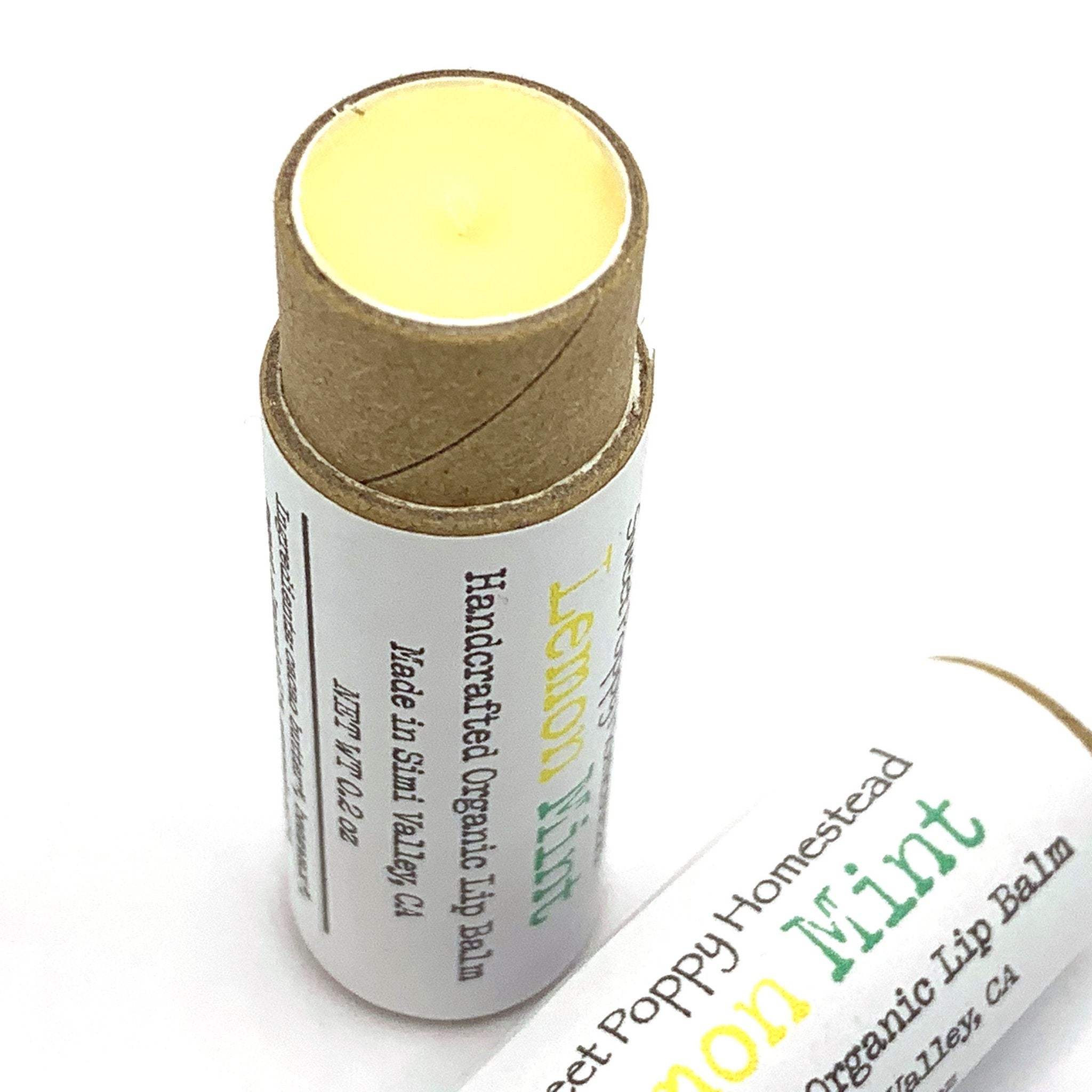 Lip balm with yellow, brown, and white packaging, Sweet Poppy Homestead Lemon Mint flavor