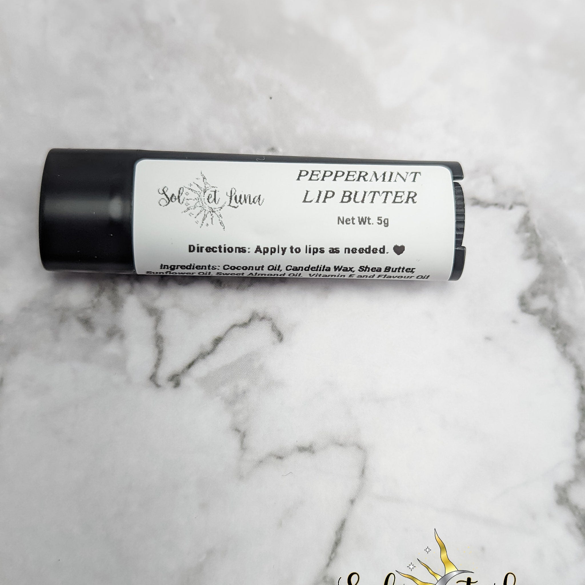 Lip butter tube with black casing, white label, and SOLETLUNA text, for lip care