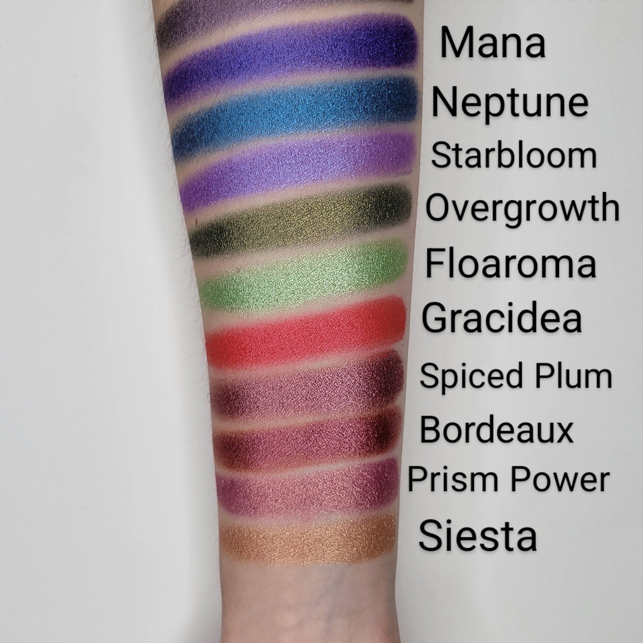 Side view of Gracidea hot pink red eyeshadow pan showing shimmer texture and compact angle