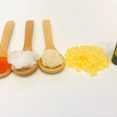 Ingredients on wooden spoons, red, white, beige, and yellow with a wooden spoon
