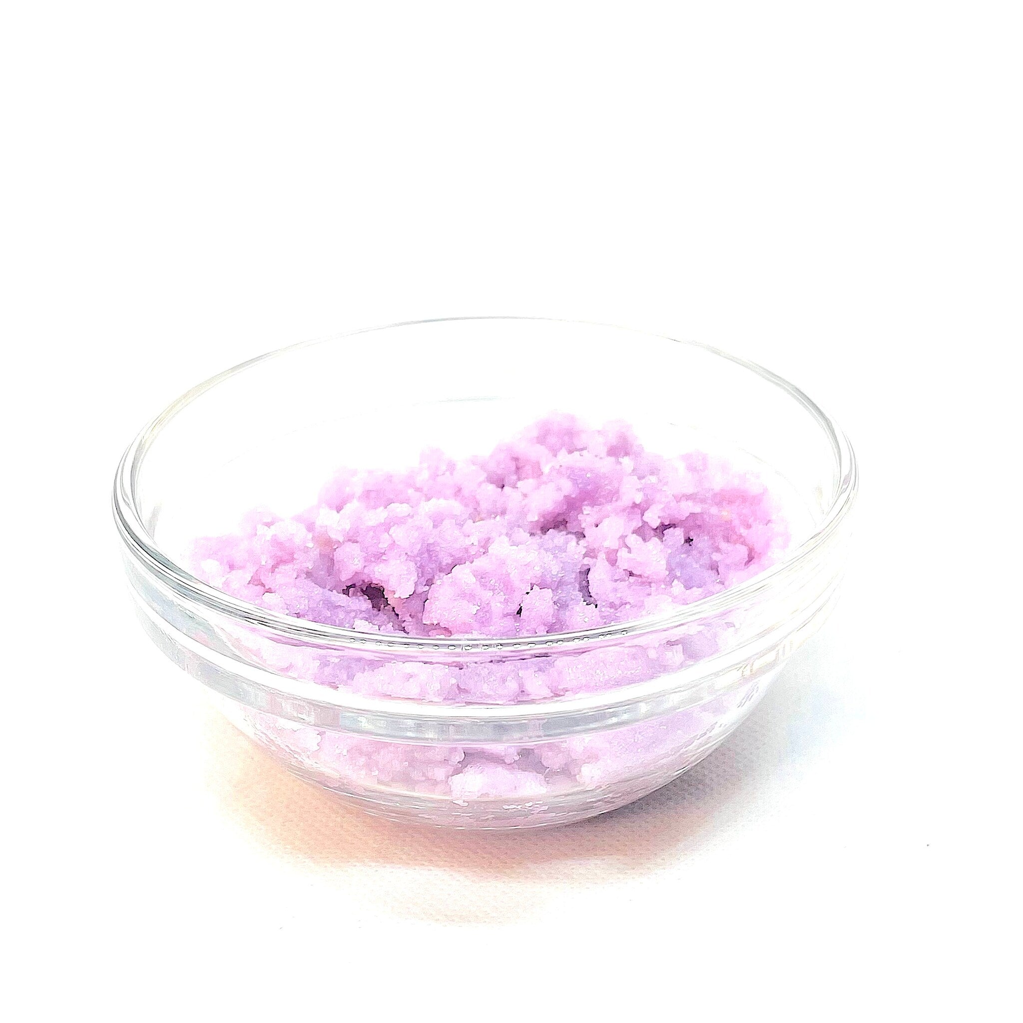 Lavender bath salts in clear glass bowl with white background