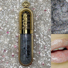 Glitter lipgloss with silver glitter, gold metallic casing, and lip application shown