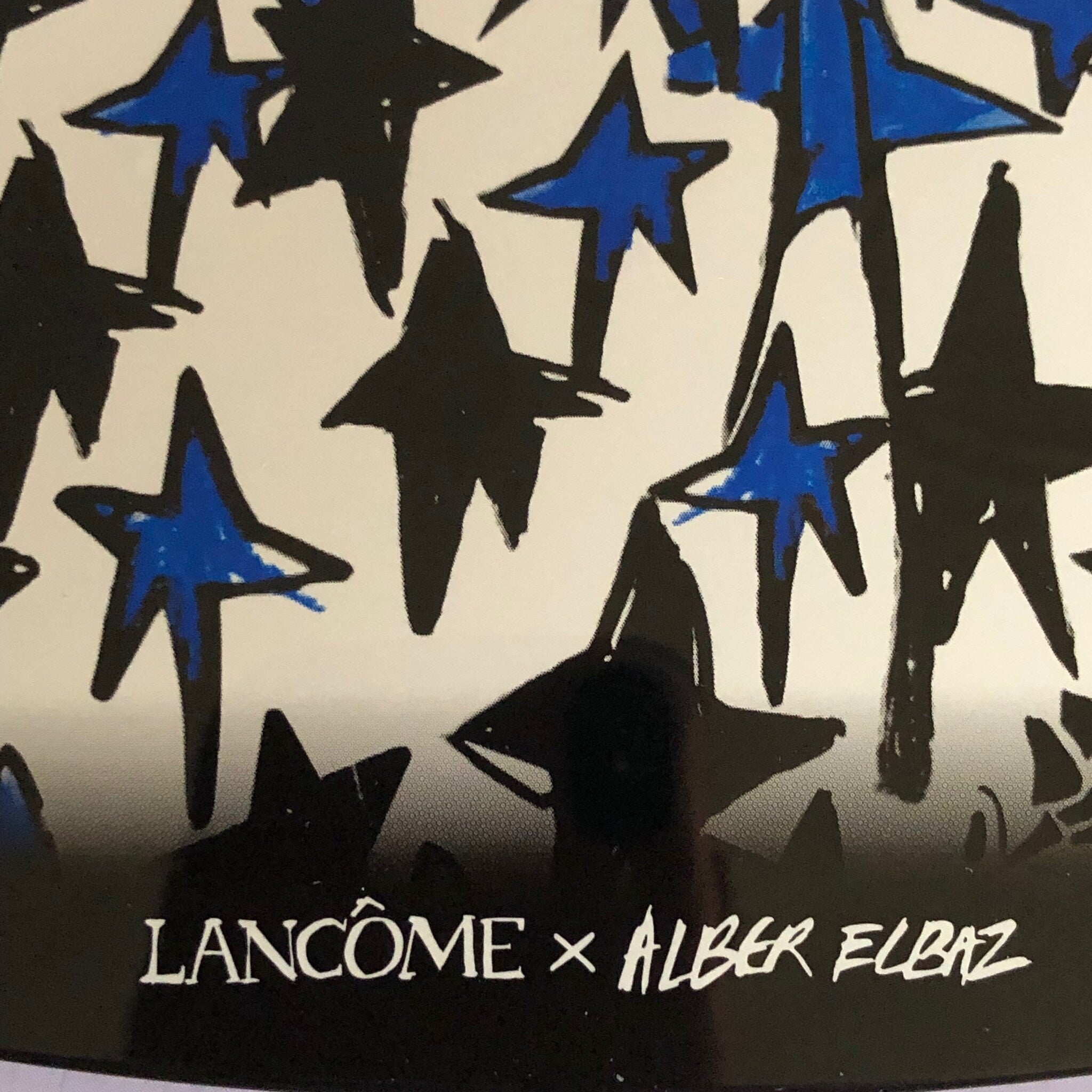 Close-up of a makeup brush applying taupe eyeshadow from the LANCÔME x Alber Elbaz palette onto eyelid
