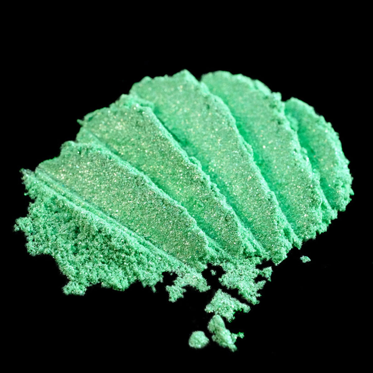 Vibrant metallic lime green loose eyeshadow pigment with iridescent candy apple shimmer in a small jar.