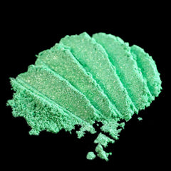 Vibrant metallic lime green loose eyeshadow pigment with iridescent candy apple shimmer in a small jar.