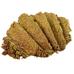 Close-up of loose dark gold eyeshadow with green glitter sparkles in metallic bronze packaging