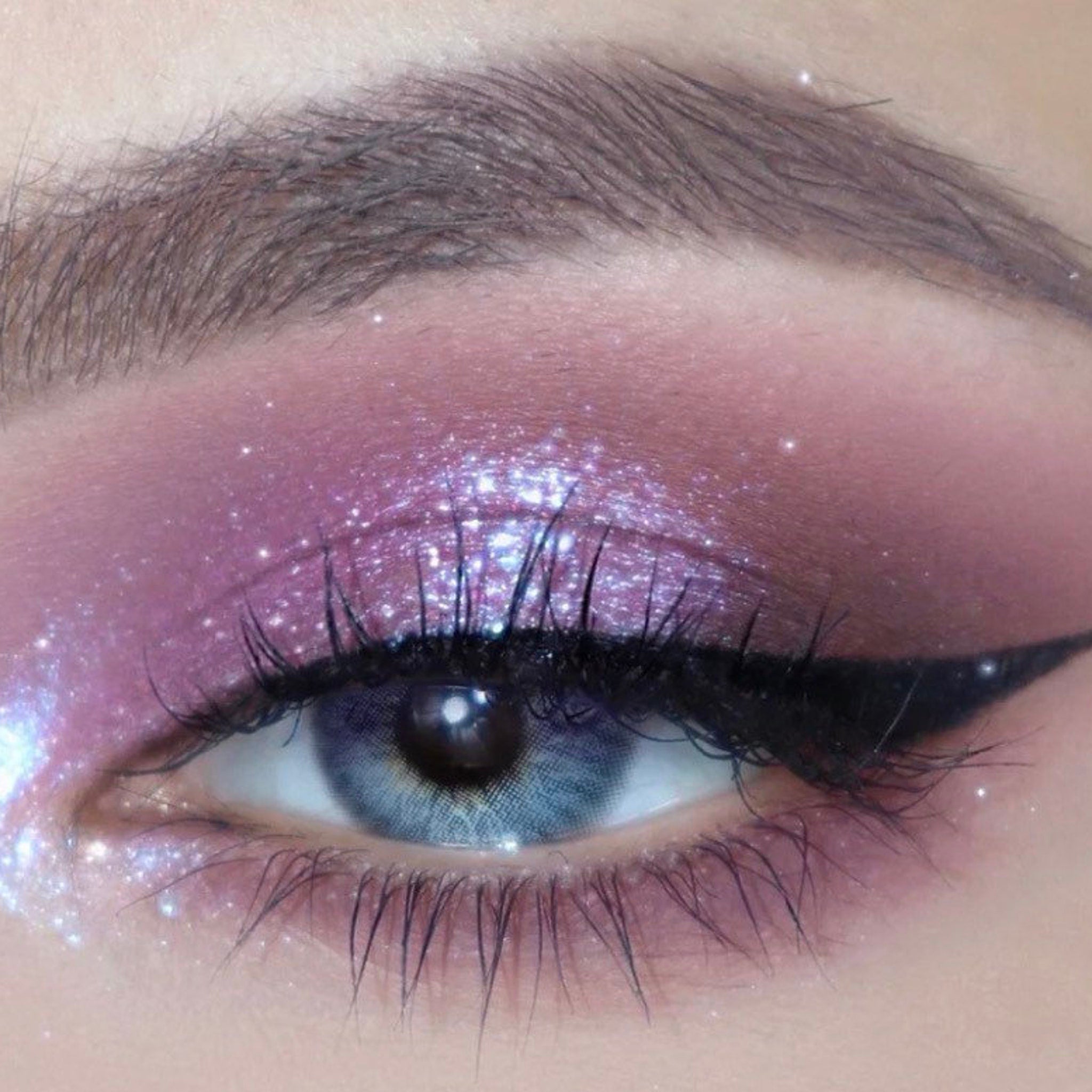 Close-up of deep purple shimmer eyeshadow pan with silver sparkles in Kawaii Gothic palette, Sailor Saturn theme
