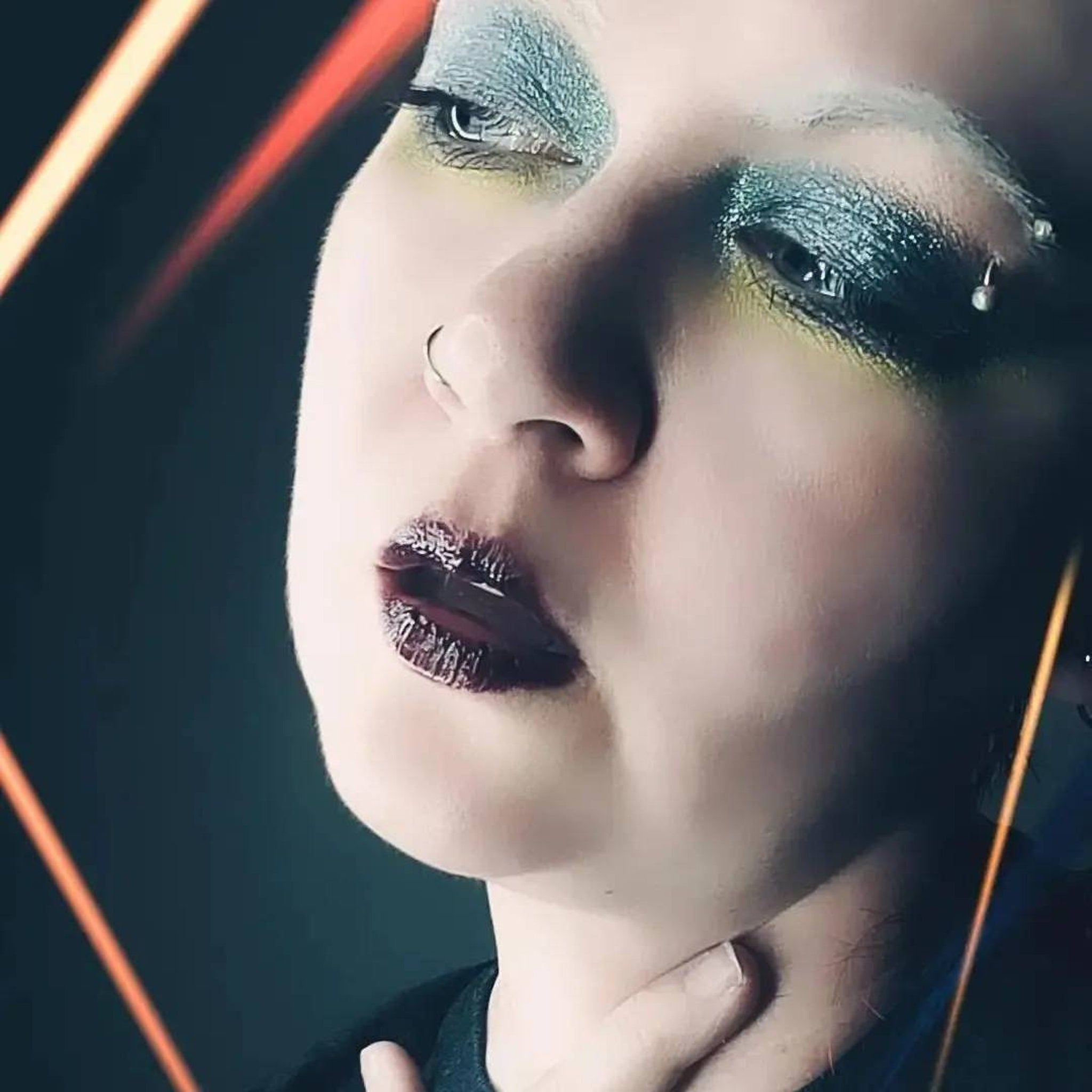 Close-up of Moonrise Chameleon Eye Shadow showcasing icy blue to grey multichrome shift with sparkling shimmer particles
