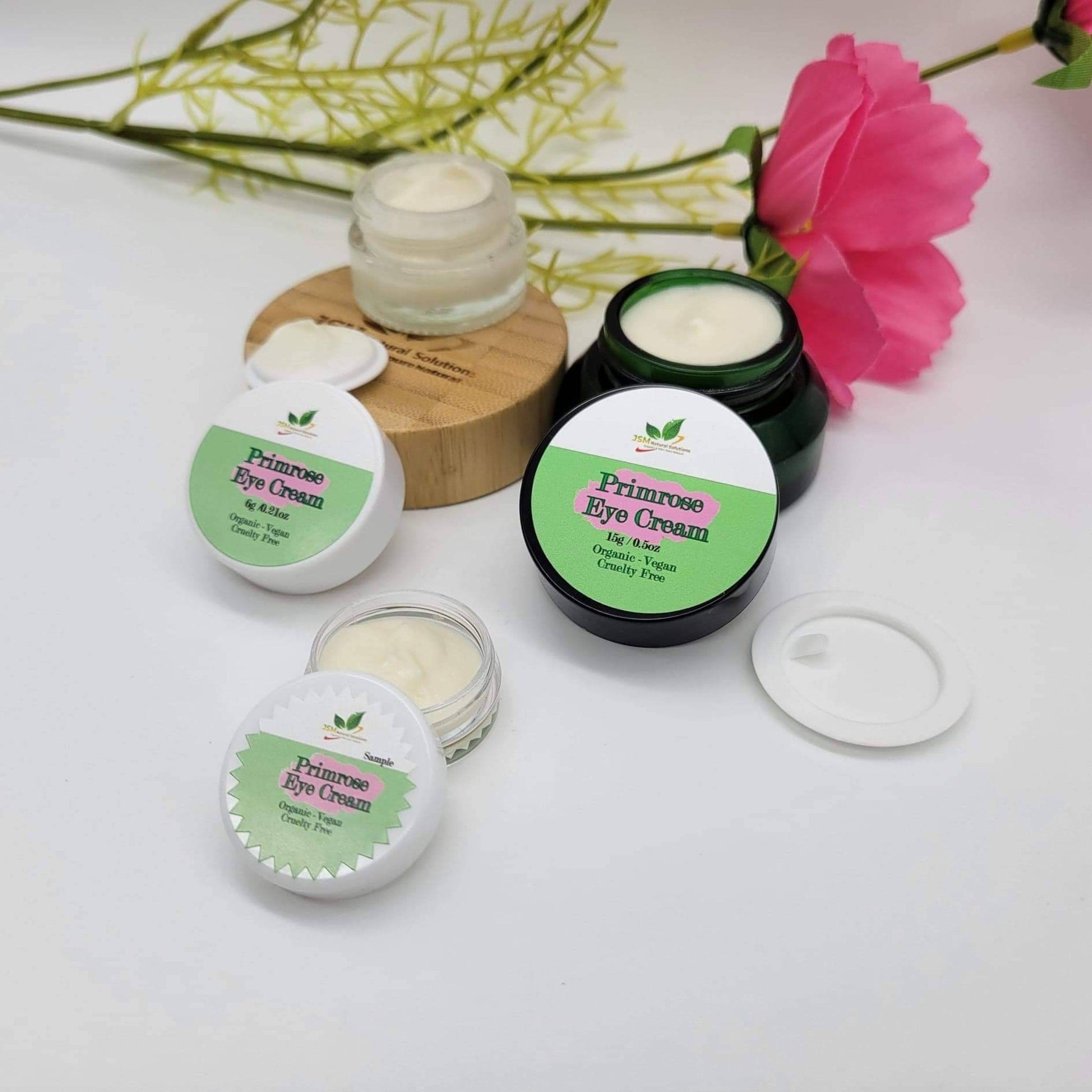 Primrose eye cream in white, green, and black containers with visible text, JSM Natural Solutions brand