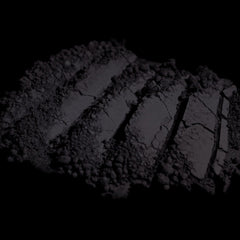 Side view of matte dark purple loose mineral eyeshadow in open jar showing fine powder texture