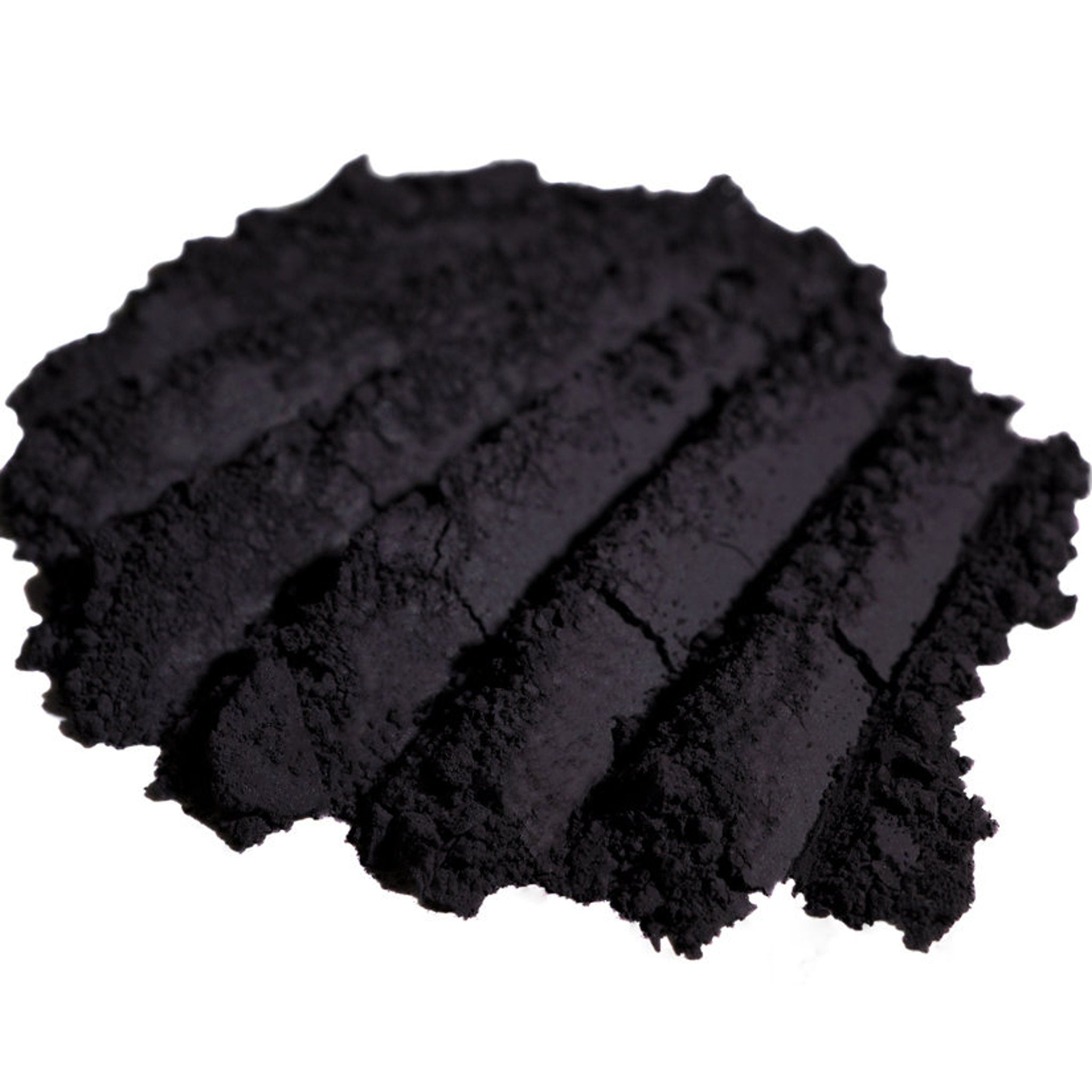 Hand applying matte dark purple loose mineral eyeshadow with a brush, creating a smoky vampy aubergine look