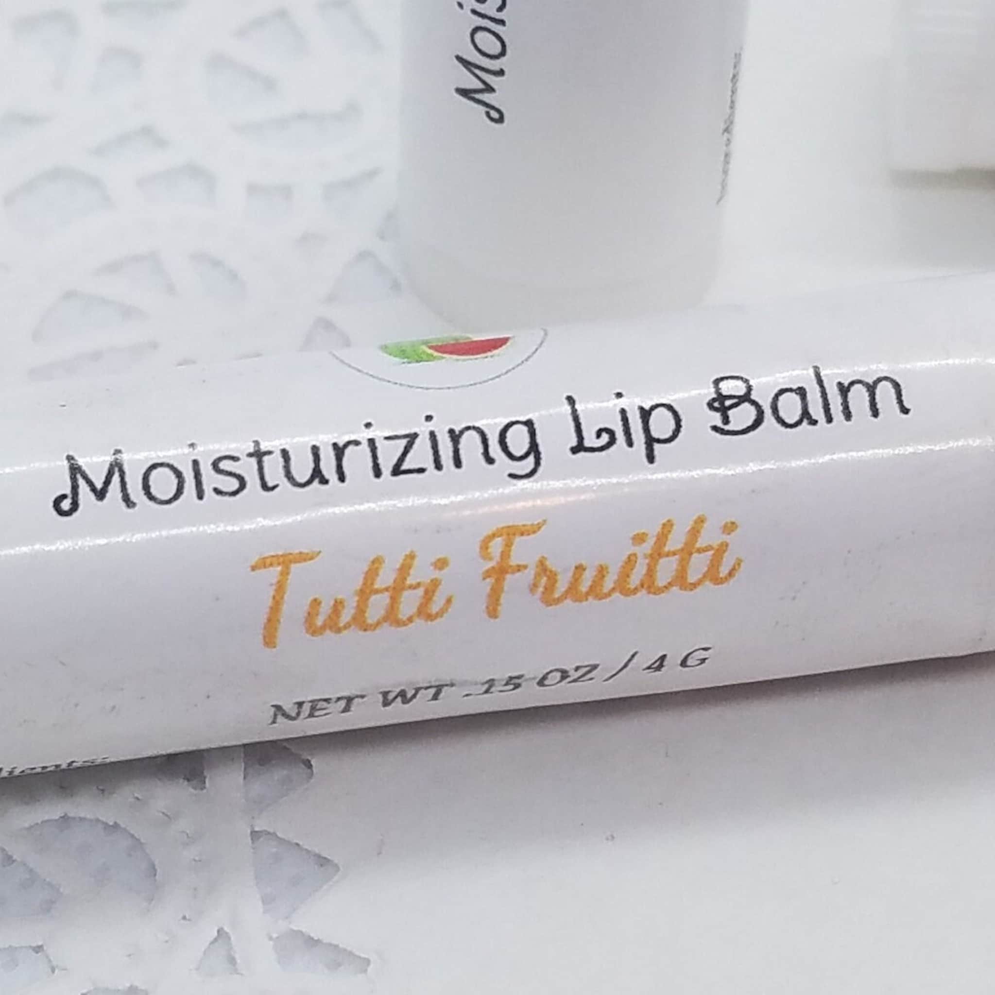 Moisturizing Lip Balm, white tube with black and orange text, Tutti Frutti flavor