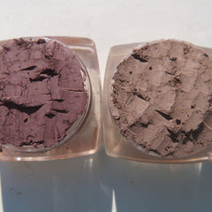 Side view of three matte brown loose pigment eyeshadows in sleek cylindrical jars with black lids