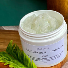 Cucumber vanilla scrub in white jar with green granules, Zemala Naturel label on wood surface