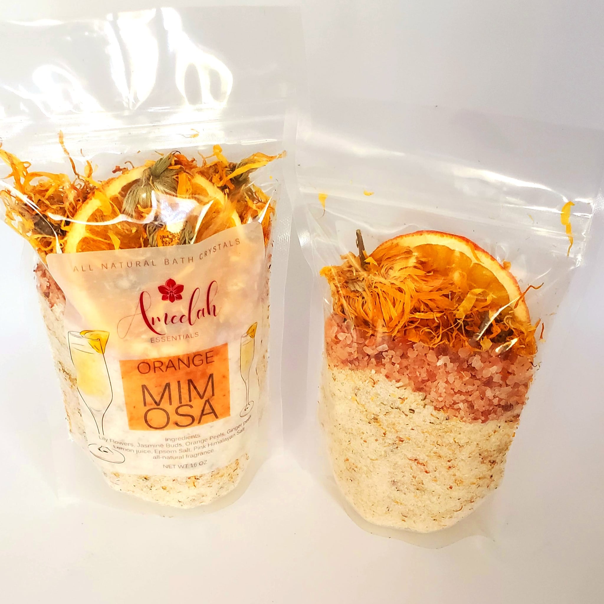Bath crystals in clear plastic bag with orange slices and dried flowers, ameelah essentials brand