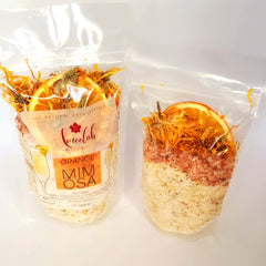 Bath crystals in clear plastic bag with orange slices and dried flowers, ameelah essentials brand