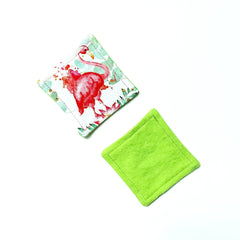 Square fabric pads with flamingo print and solid green, stitched edges