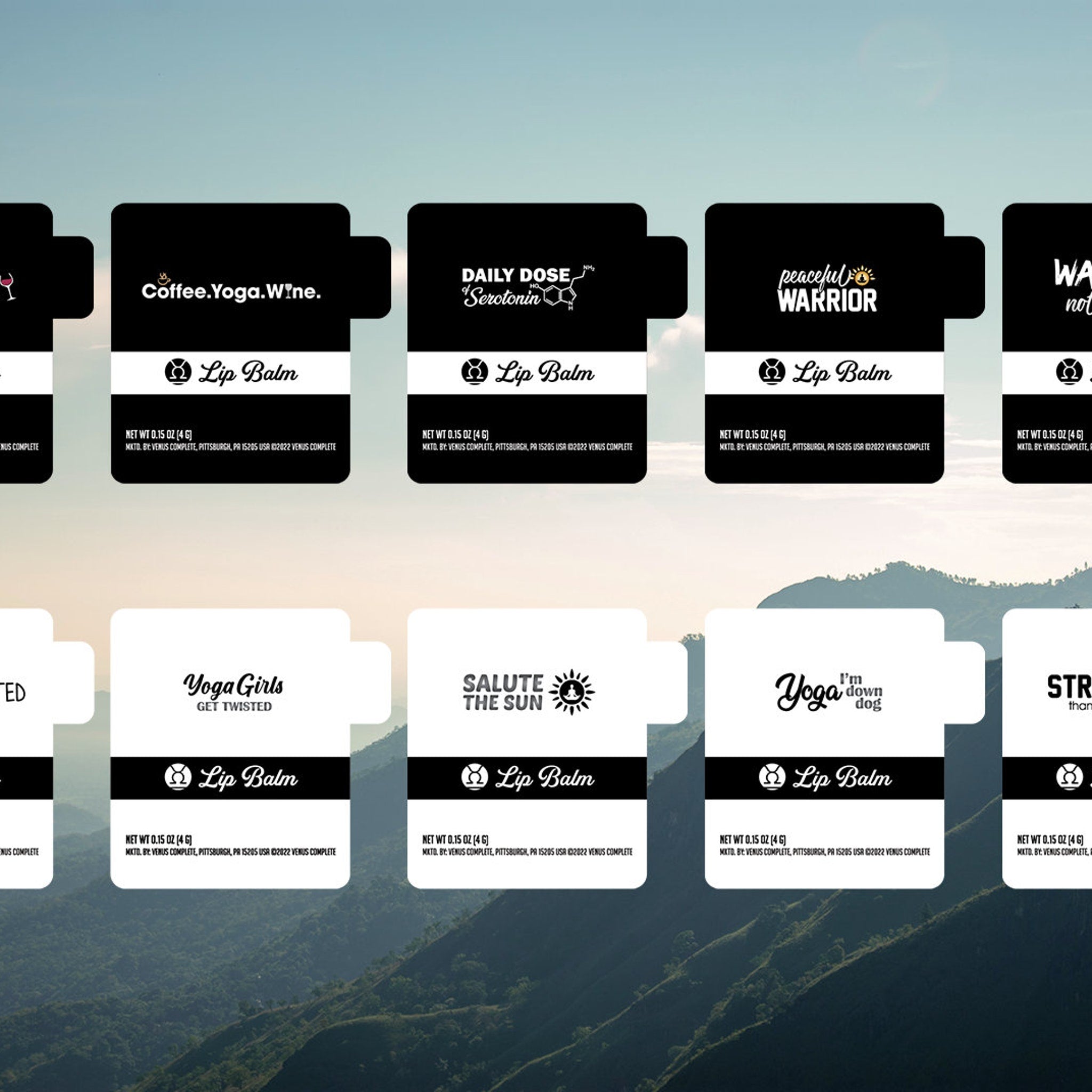 Lip balm product with black and white label, various text designs, and a mountain backdrop.