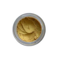 Close-up of loose vegan gold mineral eyeshadow in a small sifter jar with metallic shimmer particles