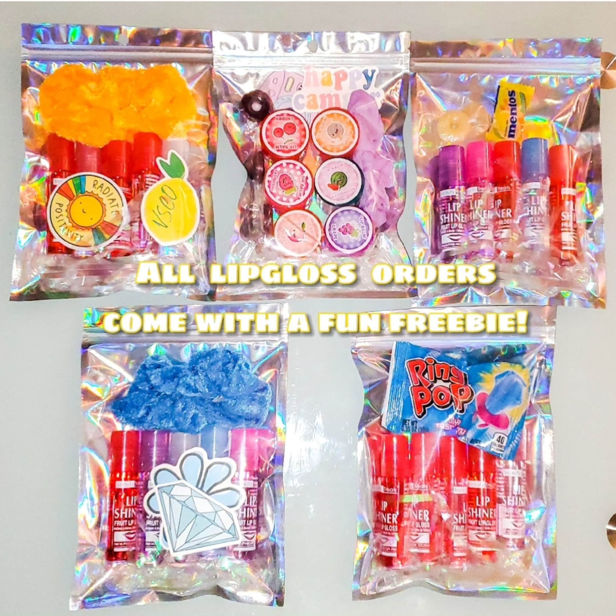 Lip gloss sets with red, pink, and purple lip gloss tubes in clear bags with freebies