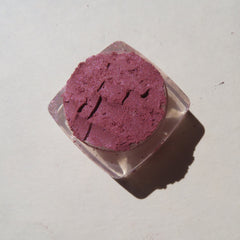 Close-up of loose dark pink mineral eyeshadow with shimmer particles, vegan and cruelty-free.