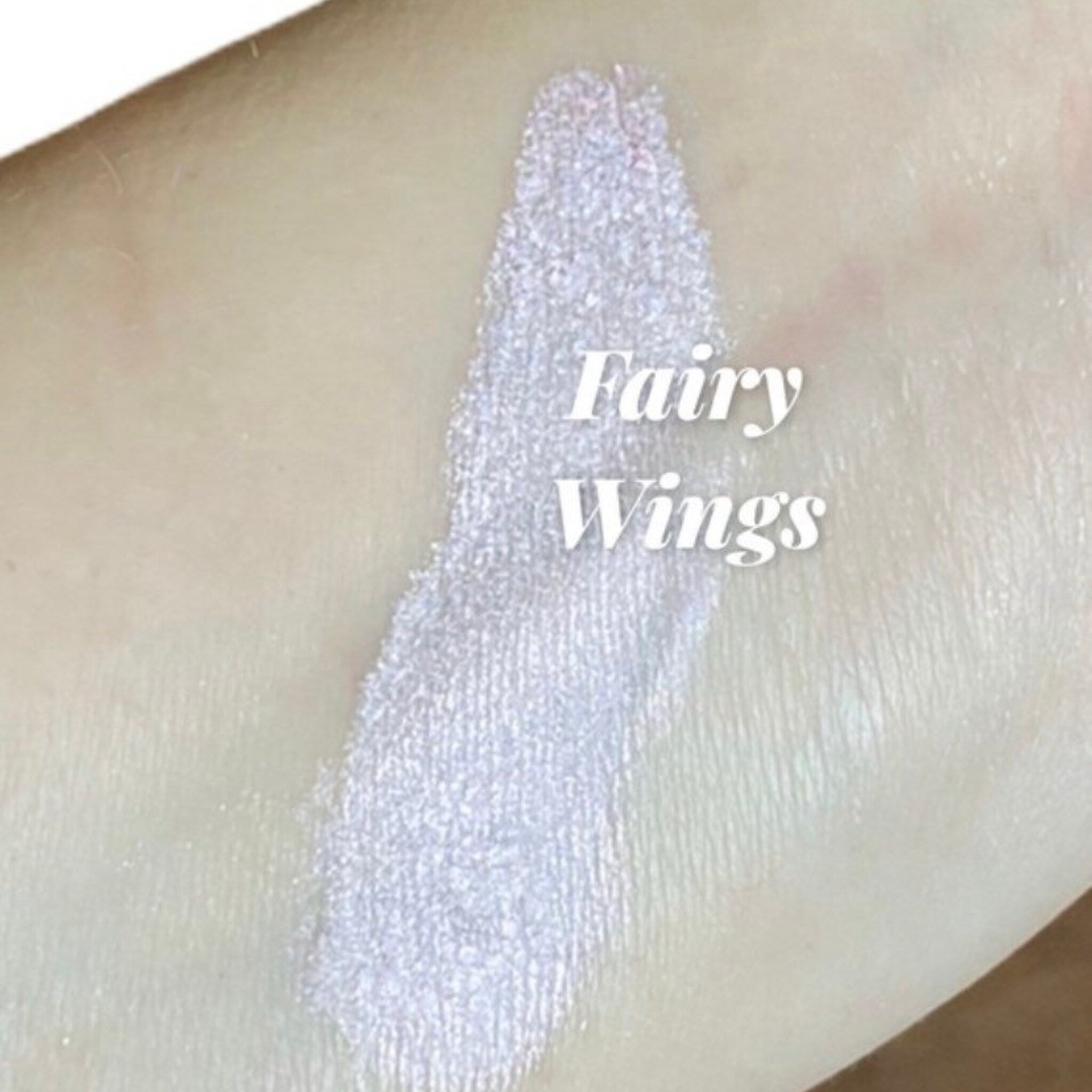 Open compact showing iridescent white and pink mineral eye shadows with mirrored interior