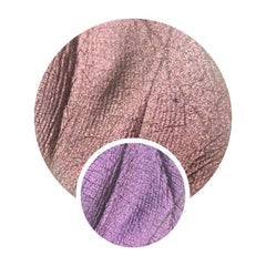 Pressed multichrome eyeshadow pan shifting from orange to pink with olive undertones in triangular compact