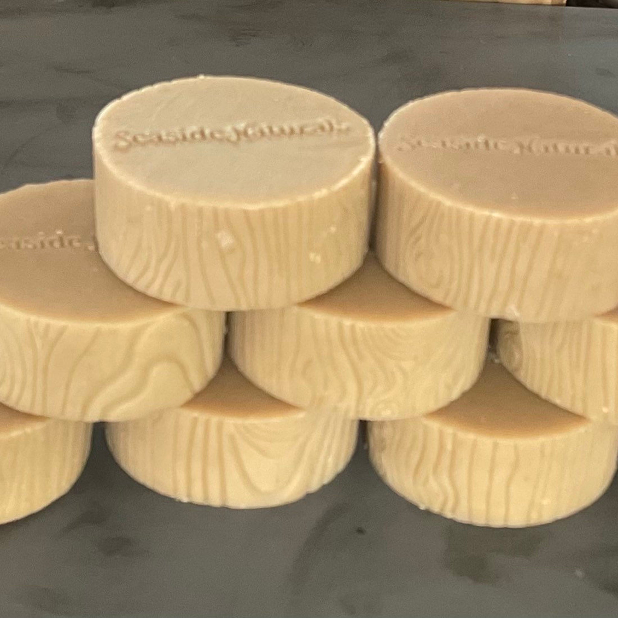 Soap bars, beige color, wood grain pattern, Seaside Naturals brand name visible