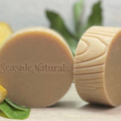 Soap bars with light brown color and Seaside Naturals text, with wood grain pattern on side