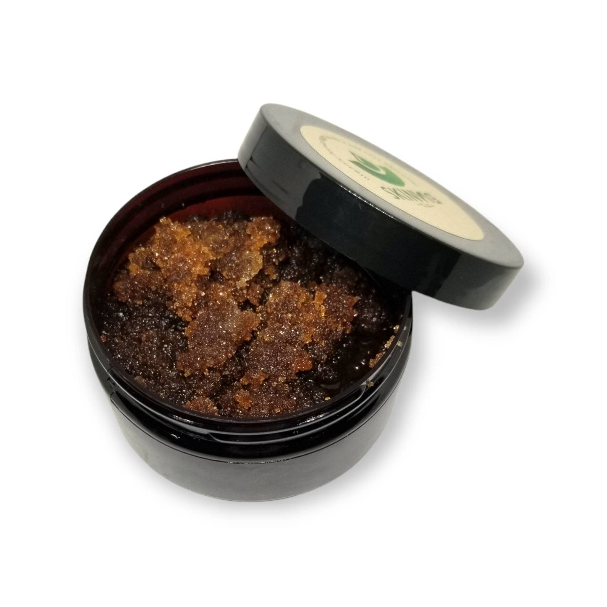 Brown sugar scrub in black jar with open lid, Skinvig branding visible