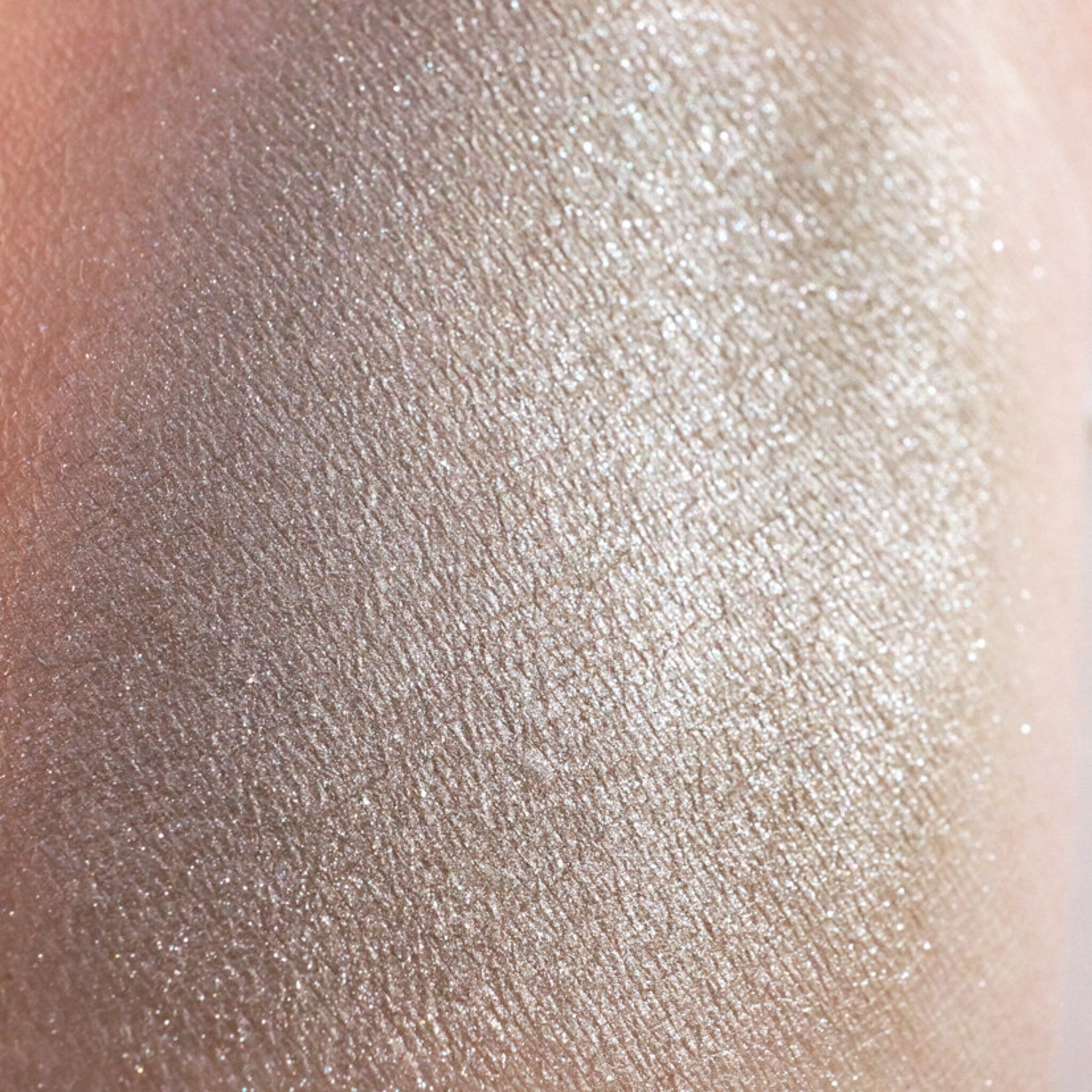 Open jar of metallic taupe and champagne loose pigment eyeshadow with silver shimmer, vegan formula