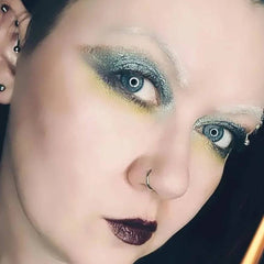 Side view of Moonrise Chameleon multichrome eye shadow pot showing icy blue to grey shift with sparkling shimmer particles