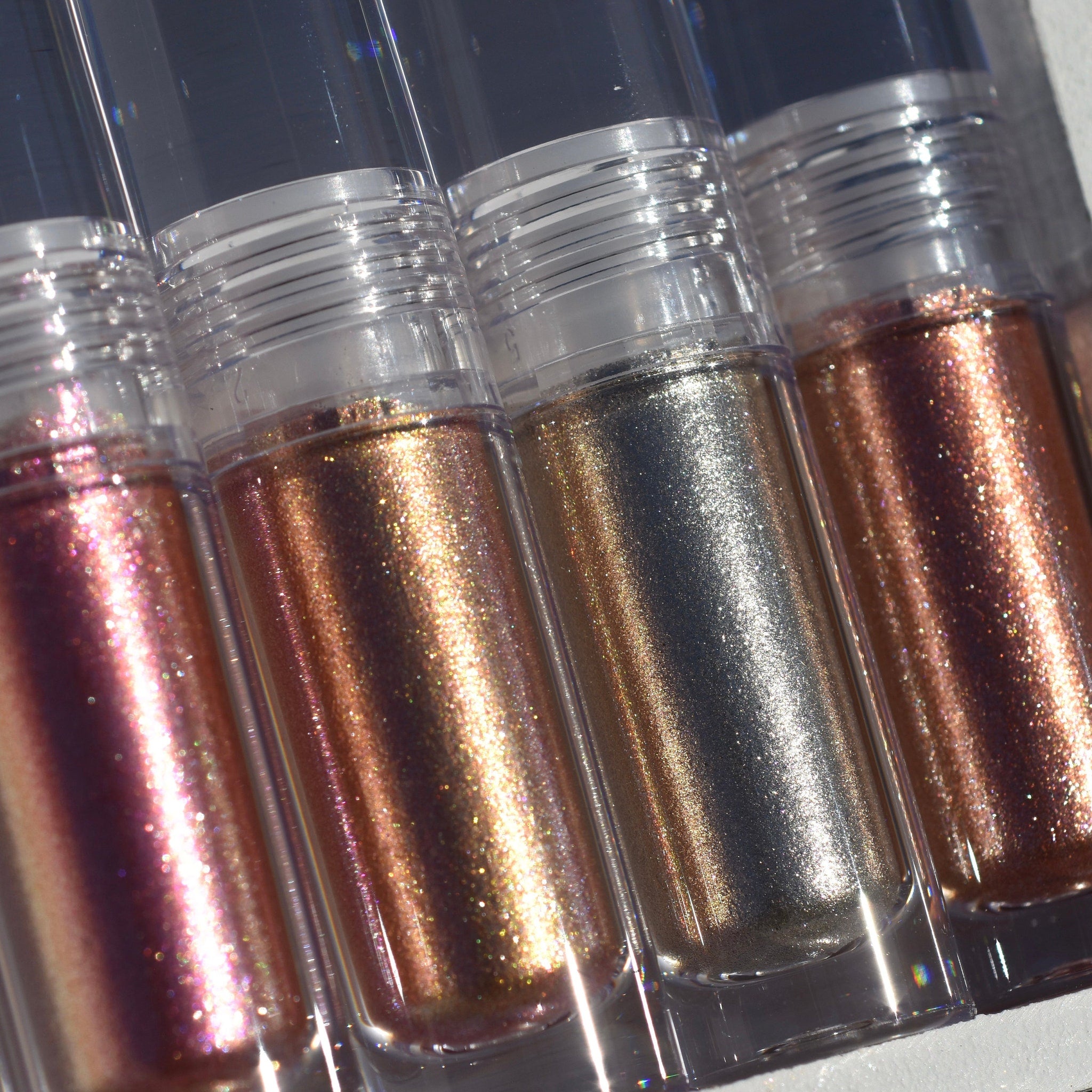 Close-up of shimmering molten eyeshadow in rich bronze with diamond sparkle, showcasing creamy texture