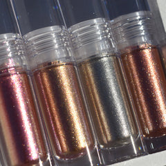 Close-up of shimmering molten eyeshadow in rich bronze with diamond sparkle, showcasing creamy texture