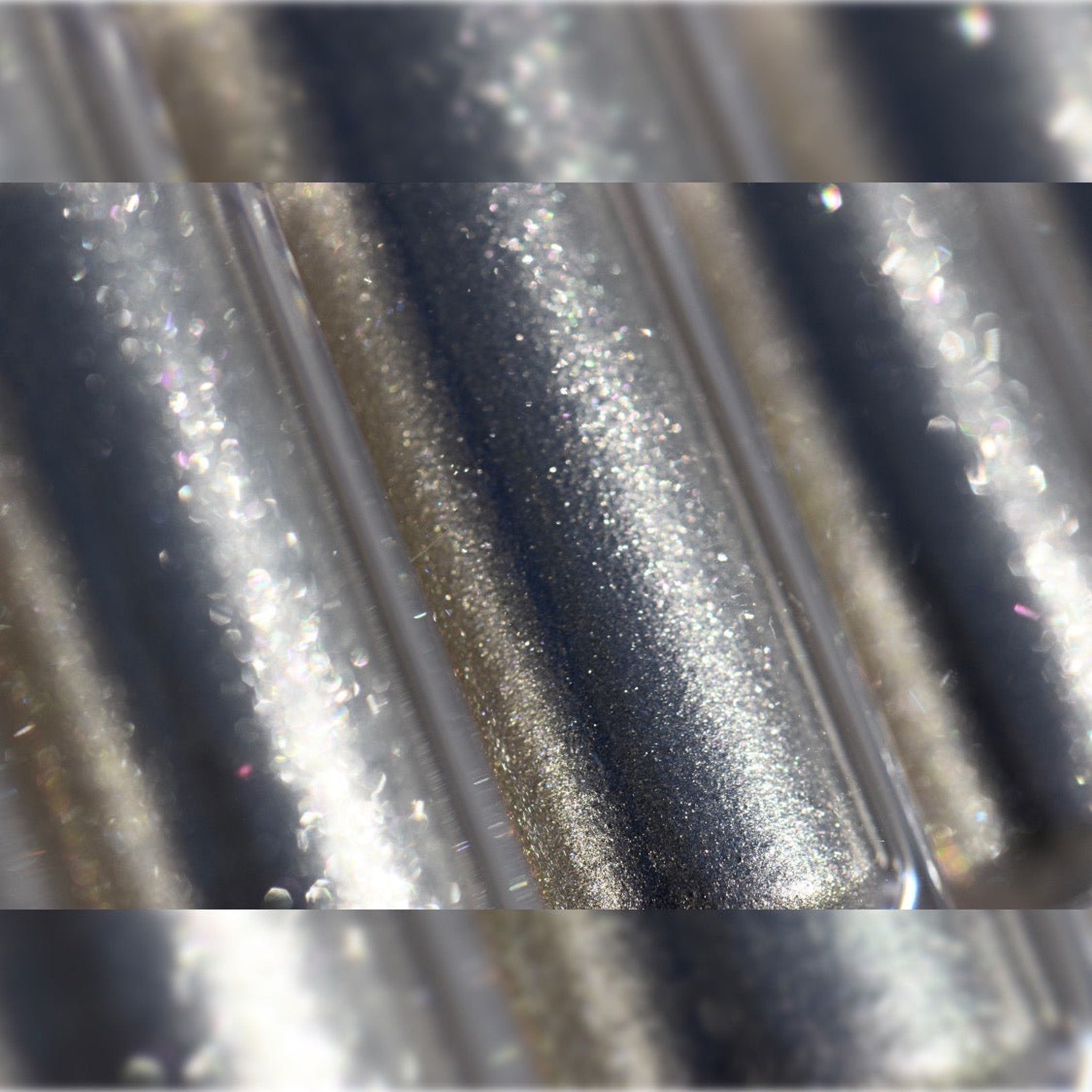 Close-up of fingertips applying shimmery molten eyeshadow in rich bronze tones to eyelid