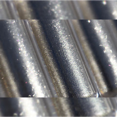 Close-up of fingertips applying shimmery molten eyeshadow in rich bronze tones to eyelid